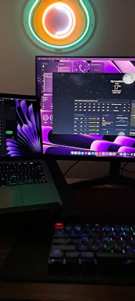 A sleek workspace with dual monitors displaying colorful data visualizations.