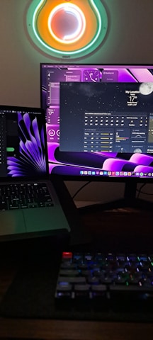 A sleek dark-themed workspace showing multiple monitors with colorful CFD simulation visuals and thermal maps.