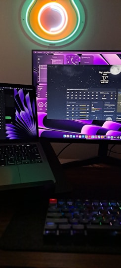 A sleek workspace with dual monitors displaying colorful data visualizations.