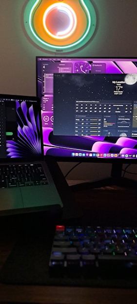 A workspace with dual monitors showing vibrant 3D animation software and sketches of characters in progress.