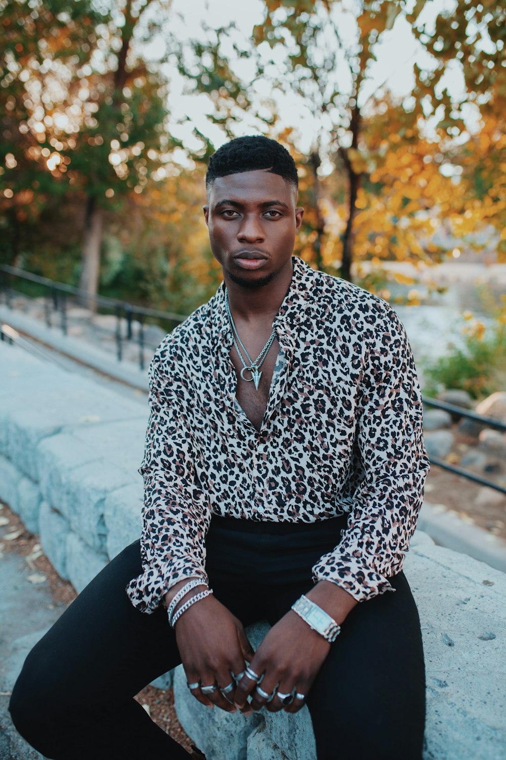 a man in a leopard print shirt and black pants