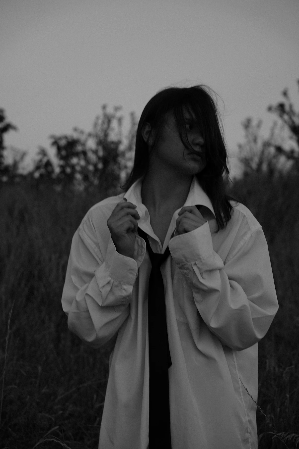 A woman in an oversized white shirt — sculptural and architectural
