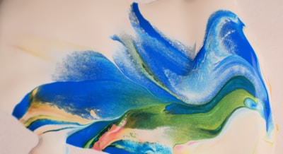 A vibrant watercolor splash blending shades of blue and gold, evoking the ebb and flow of human emotion.