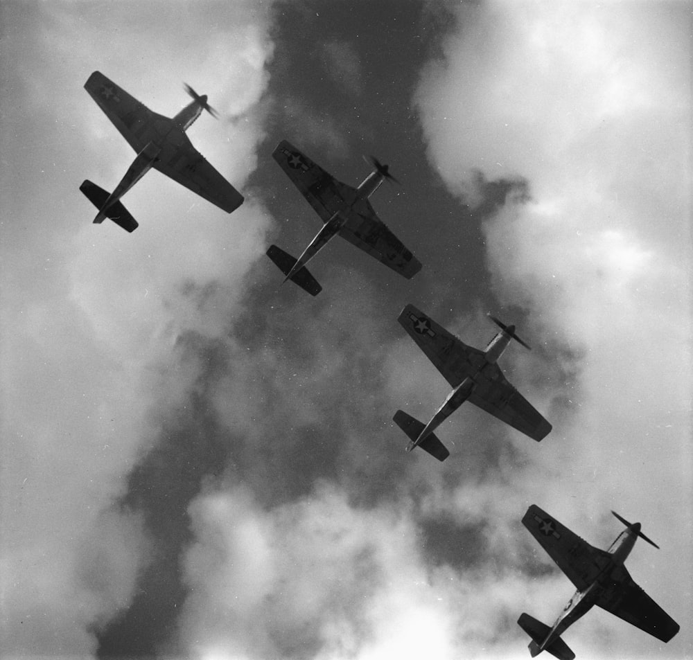 Four P-51 Mustangs flying in formation