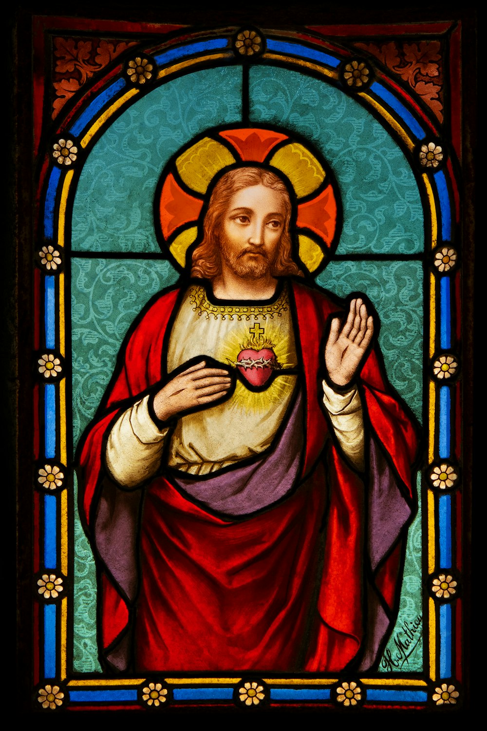 a stained glass window with a man holding a heart