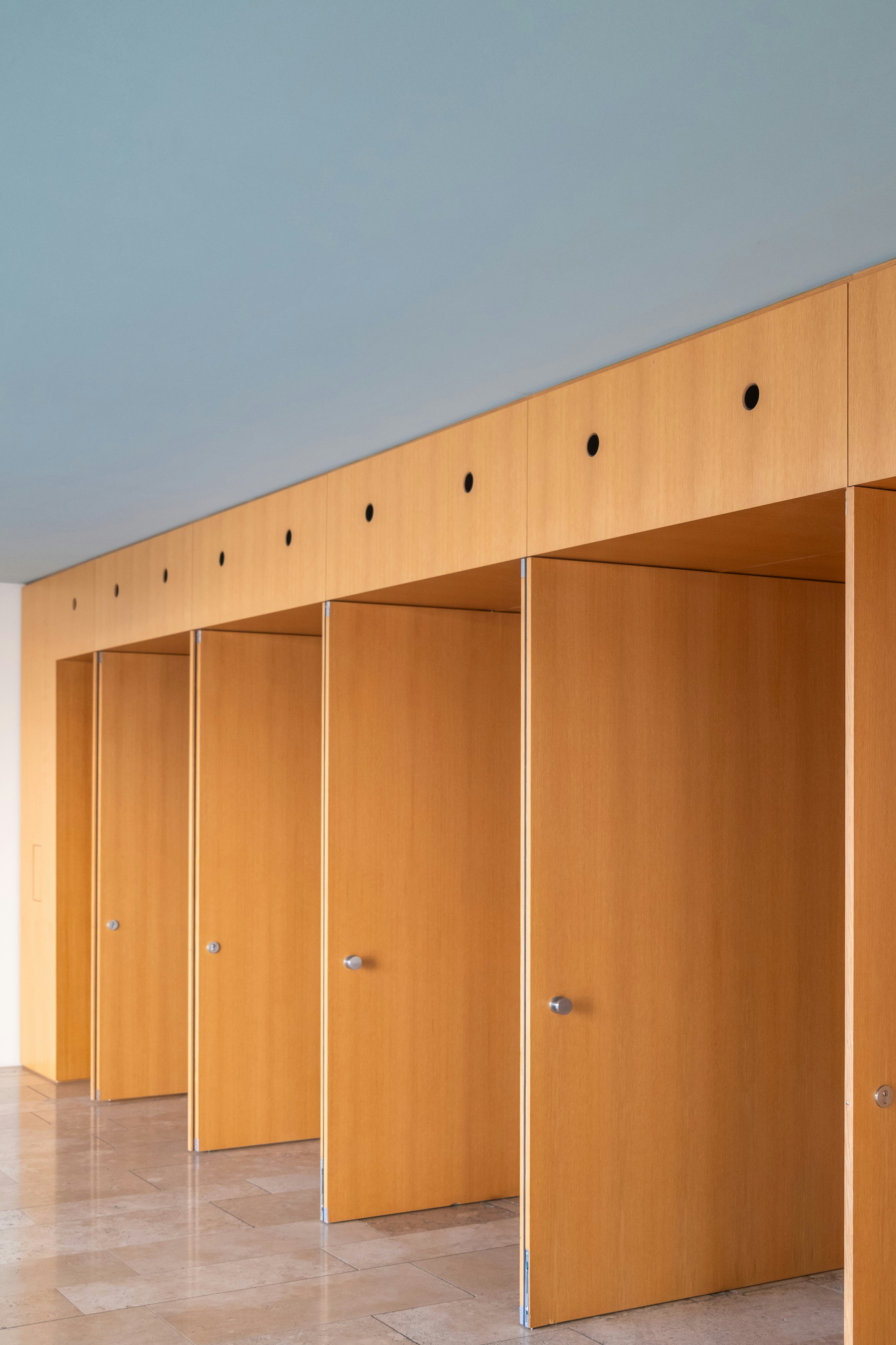 a row of wooden stalls sitting next to each other