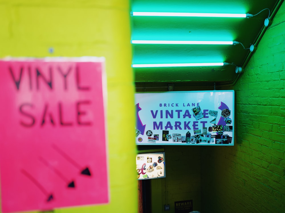 a neon green and yellow wall with a neon sign