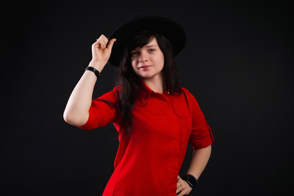 a woman in a red shirt and a black hat