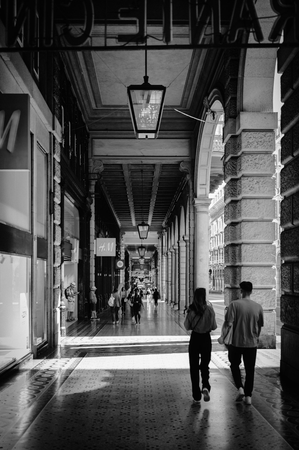 a couple of people walking down a hallway