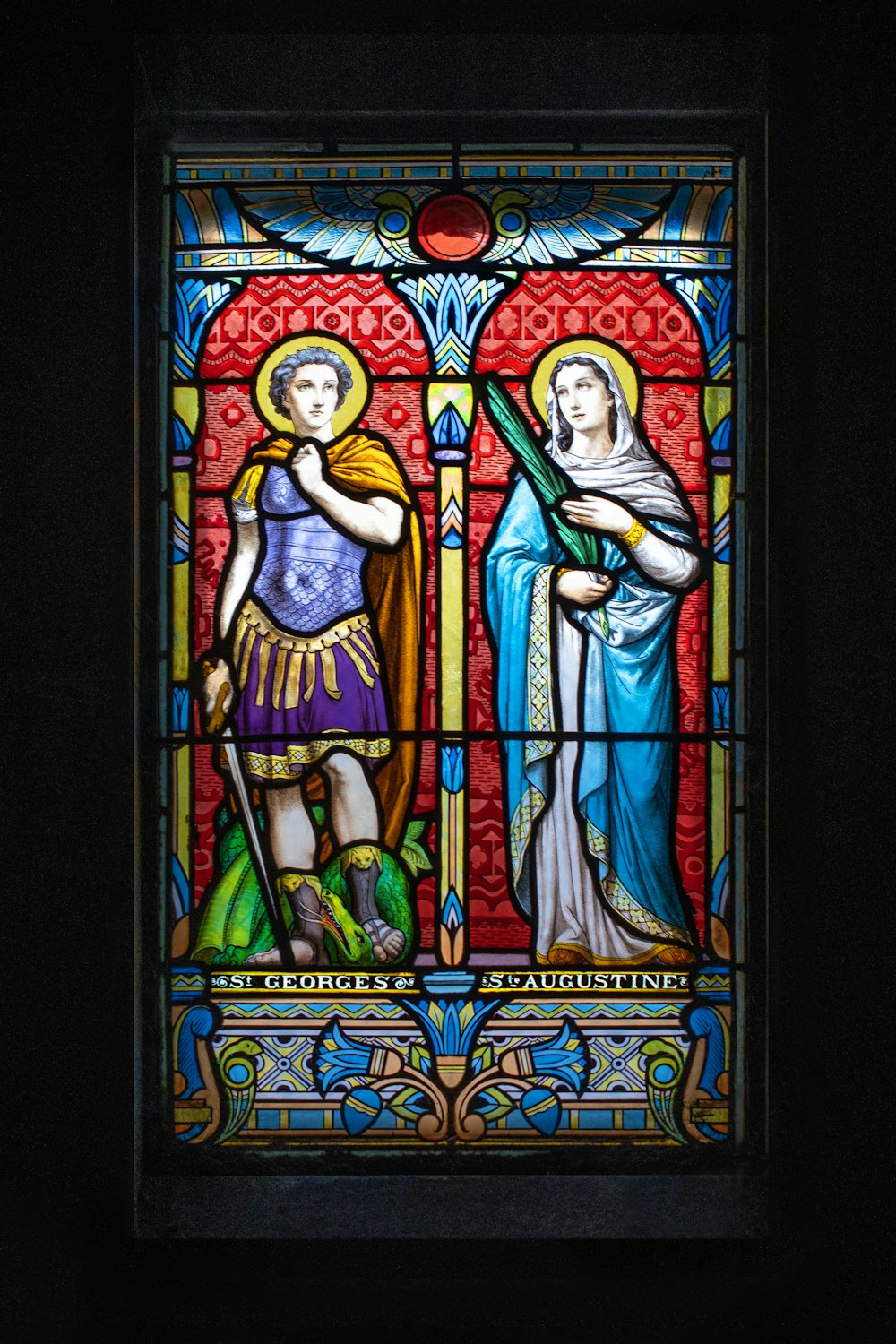 a stained glass window with two women in it