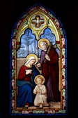 a stained glass window with a woman and child