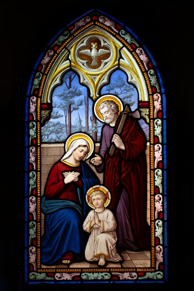 a stained glass window with a woman and child