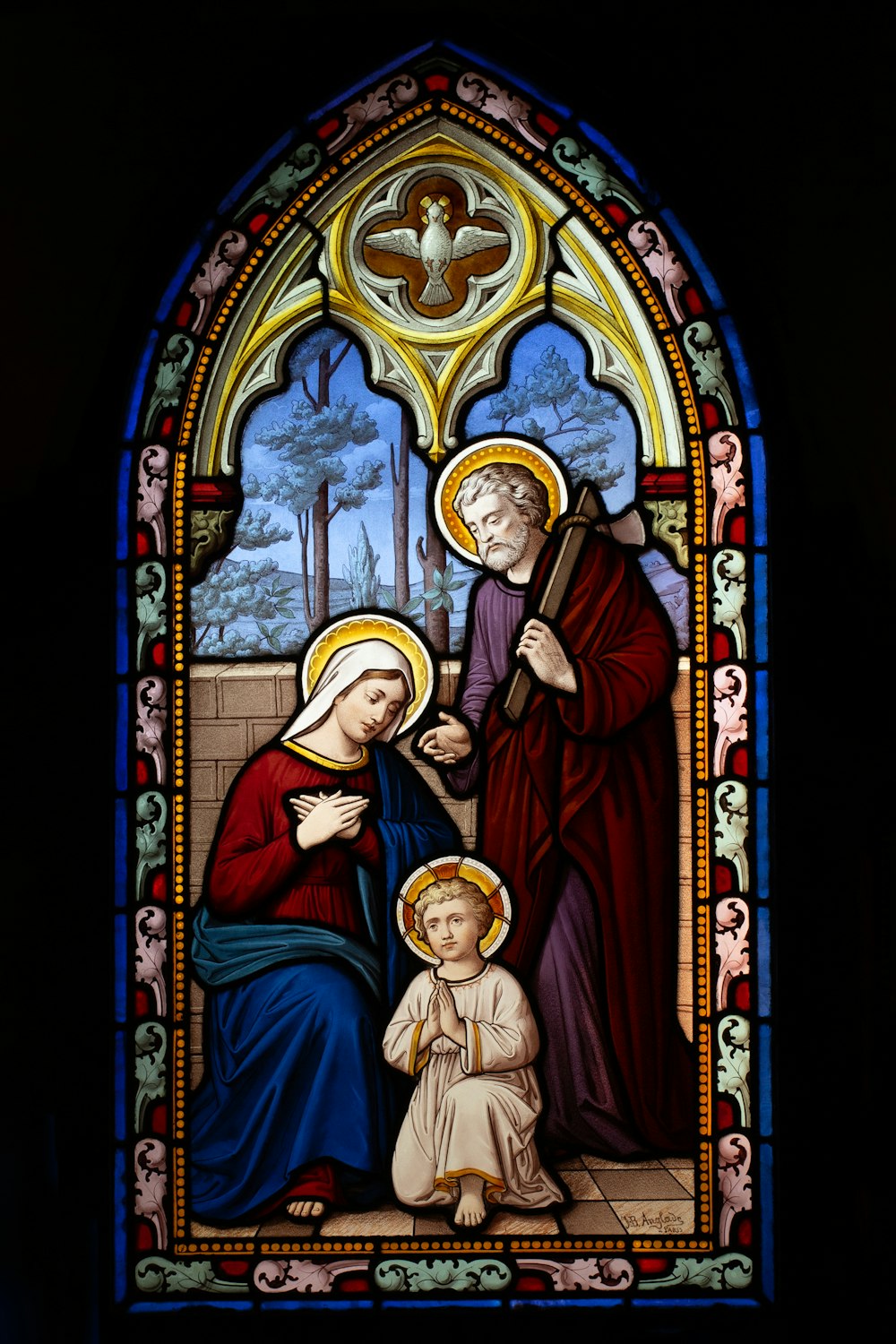 a stained glass window with a woman and child
