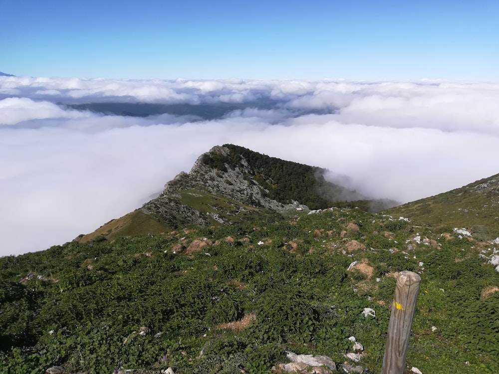 a view of a mountain with low lying clouds