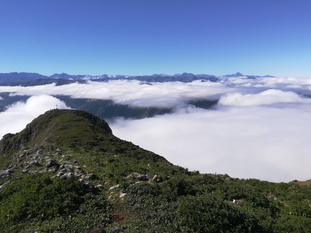 a view of the top of a mountain covered in clouds