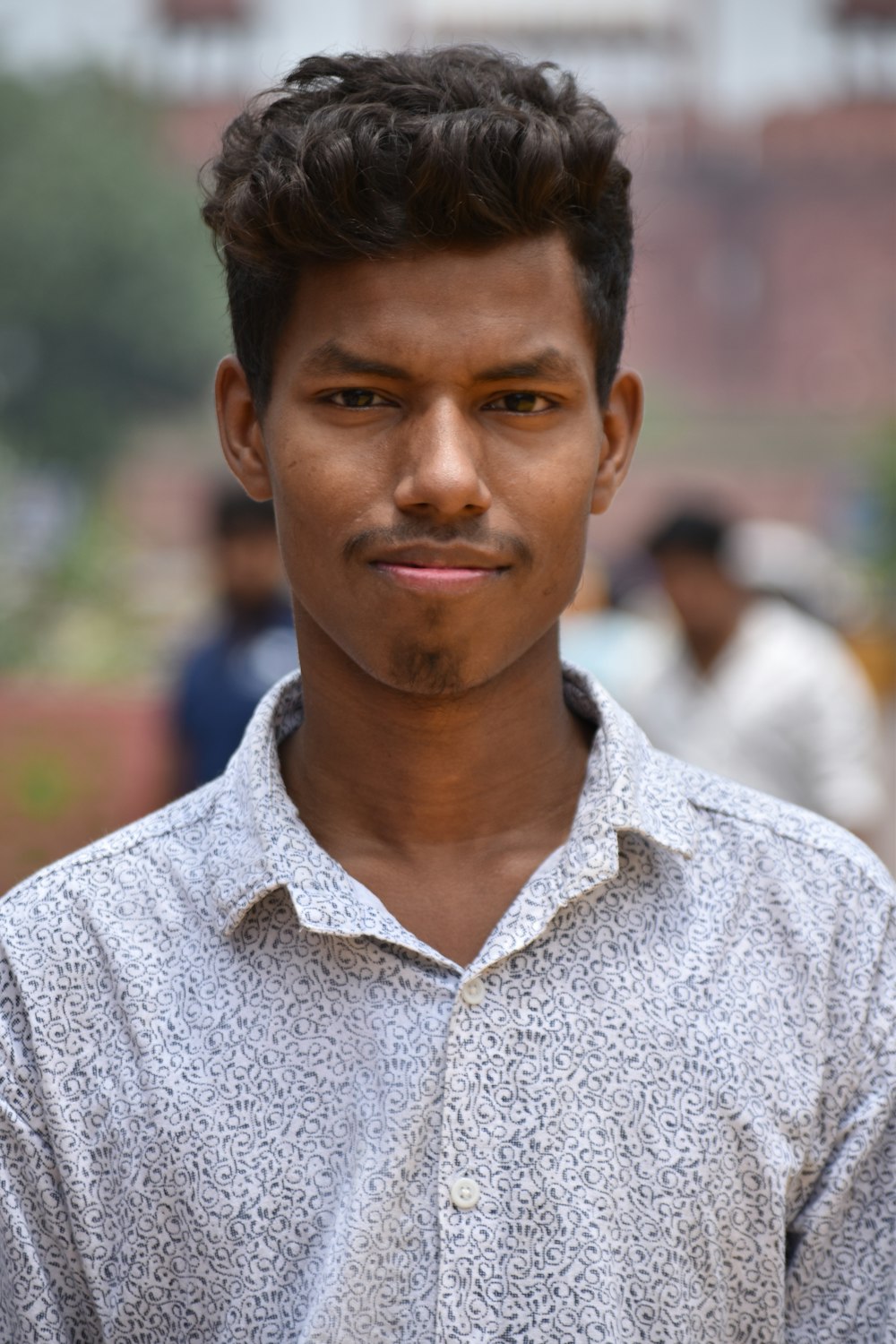 a man in a white shirt standing in front of a group of people