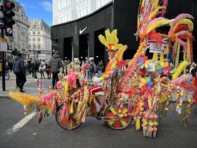 Close-up of a cyclist wearing a vivid outfit, holding a two-sided banner above their head with bold branding.