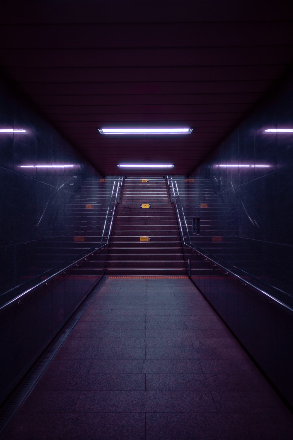 a long hallway with stairs leading up to the ceiling