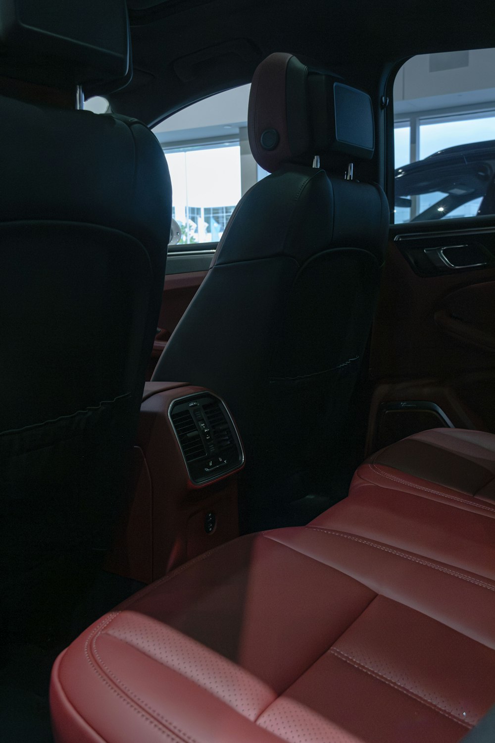 the interior of a car with red leather seats