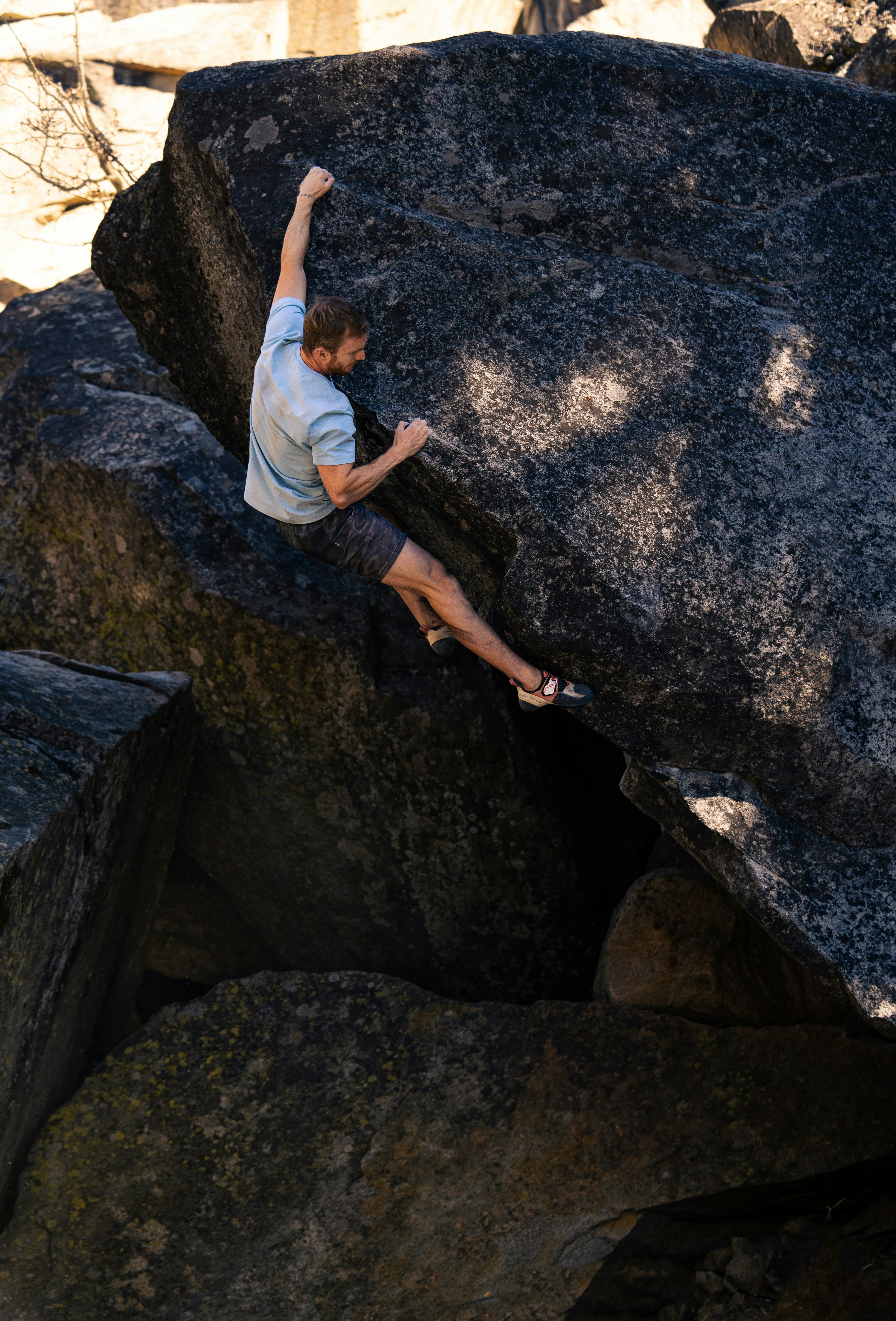 a man is climbing up a large rock