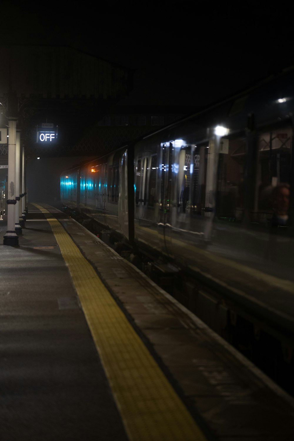 a train traveling down tracks next to a train station