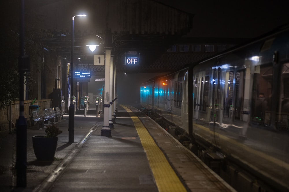 a train on a train track at night