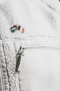 Close-up of rugged military-style jacket with Spartan emblem