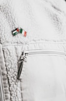 Close-up of matte black jacket sleeve featuring embossed 5pidxx logo.