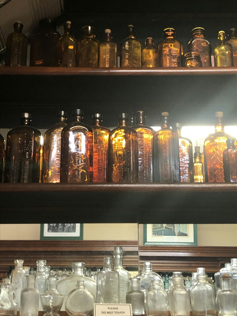 a shelf filled with lots of glass bottles