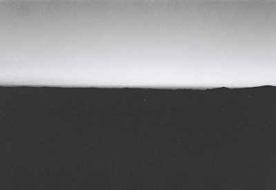 A minimalist black-and-white landscape photograph emphasizing horizon and scale.