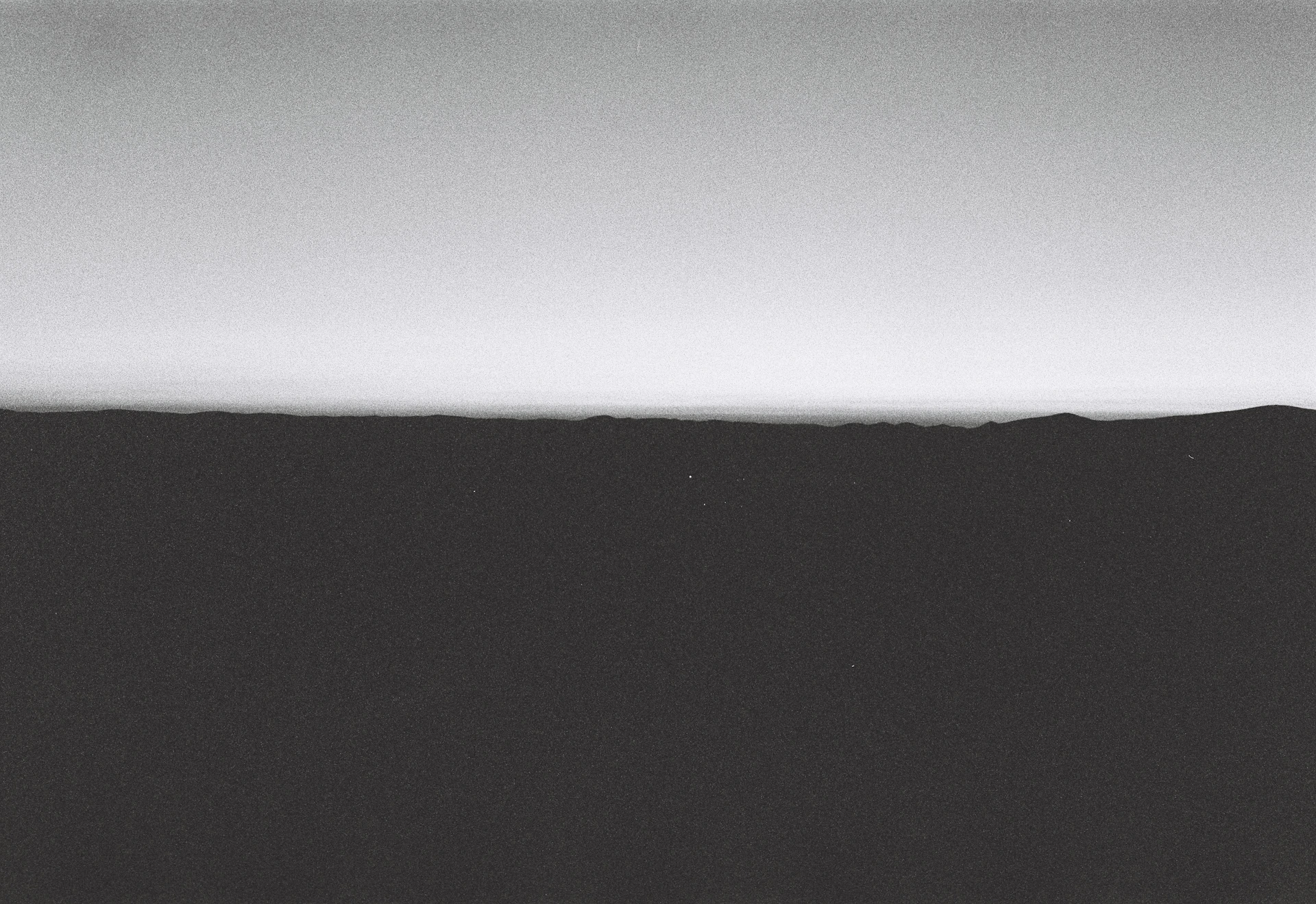 A minimalist black and white sketch of a serene landscape with delicate linework.