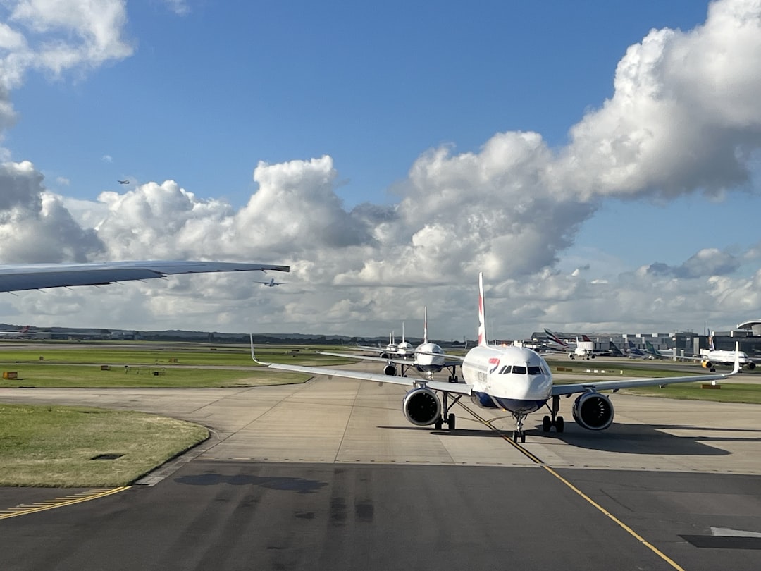 a large jetliner sitting on top of an airport runway, Planes queuing at London Heathrow