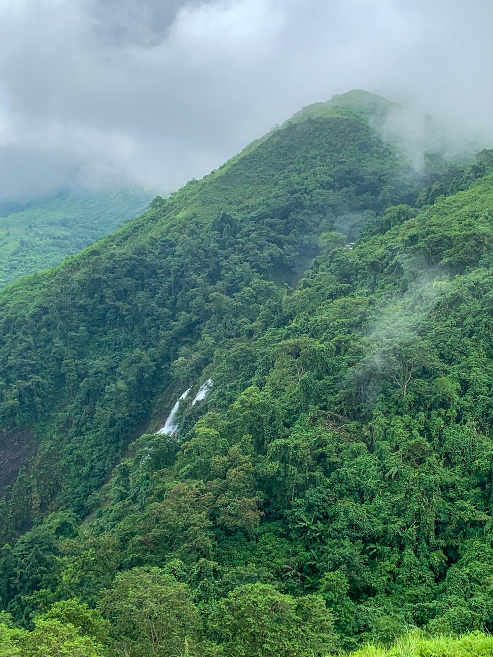 a mountain with a waterfall in the middle of it