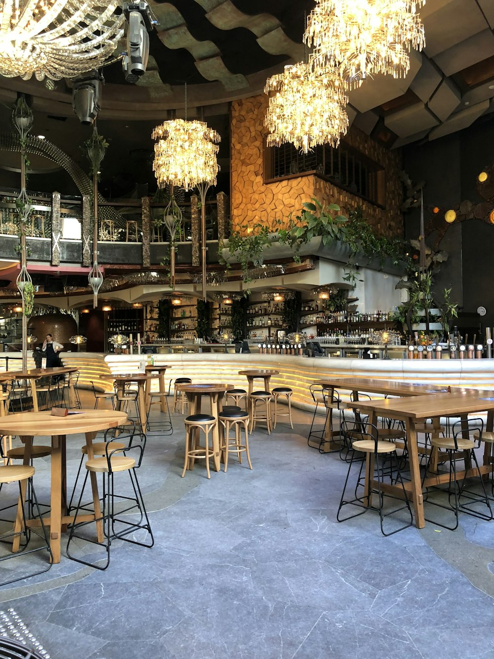 a restaurant filled with lots of wooden tables and chairs