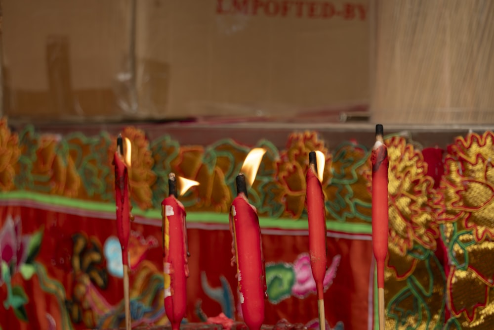 a group of red candles sitting on top of a table