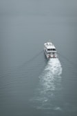 A scenic view of a boat navigating through calm waters.