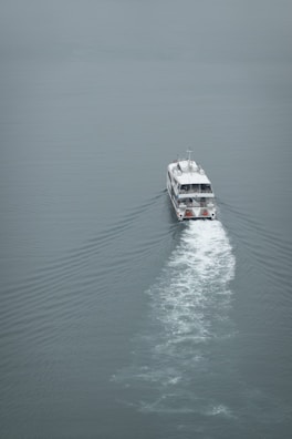 A scenic view of a boat navigating through calm waters.