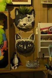 Colorful cat products such as scratching posts, food bowls, and playful toys on a shelf.