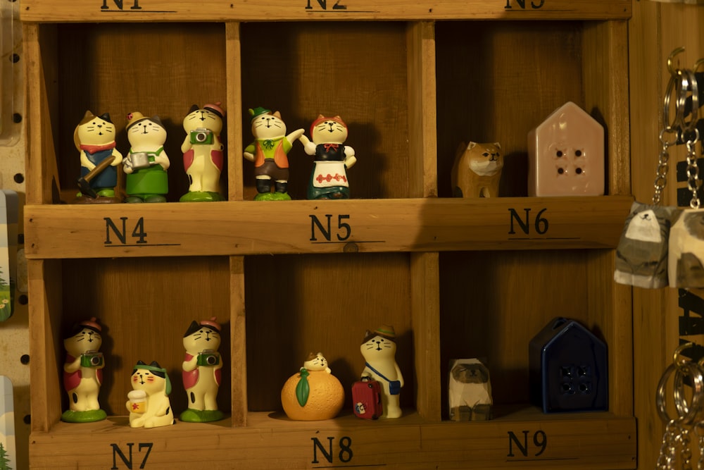 a wooden shelf filled with lots of figurines