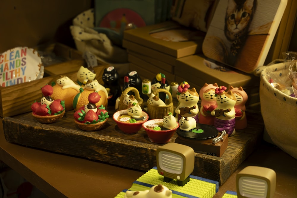 a wooden table topped with lots of small figurines