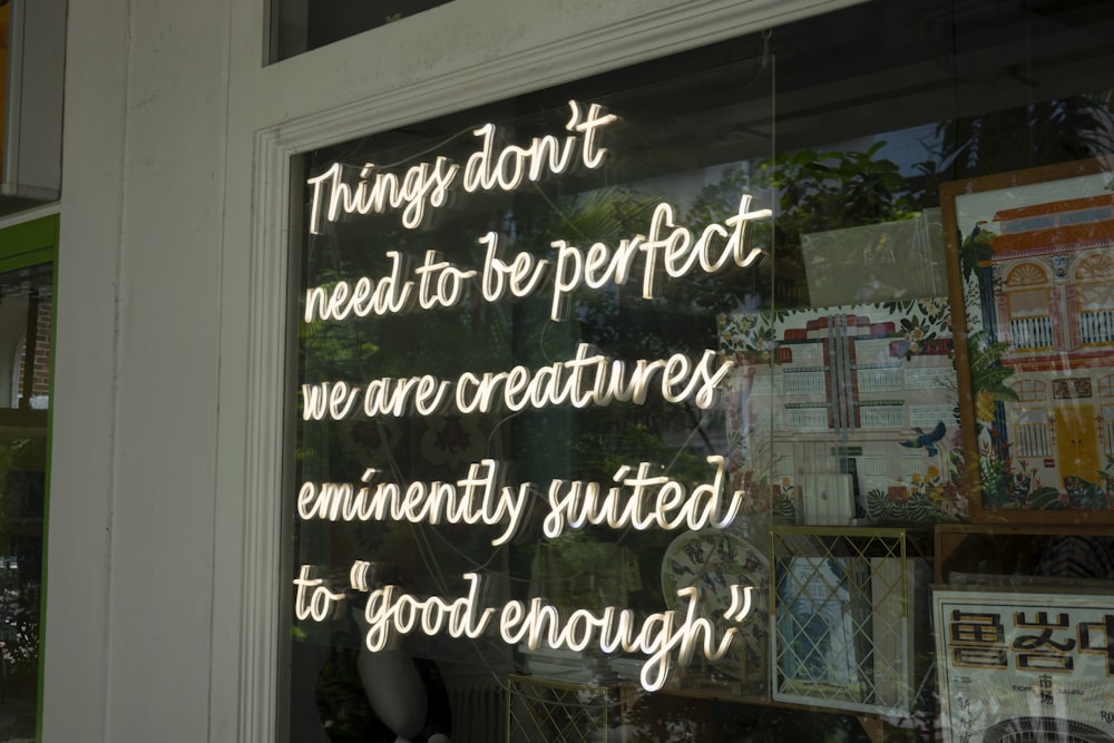 a window with a sign that says things don't need to be perfect