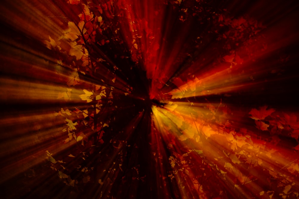 a red and yellow background with a burst of light