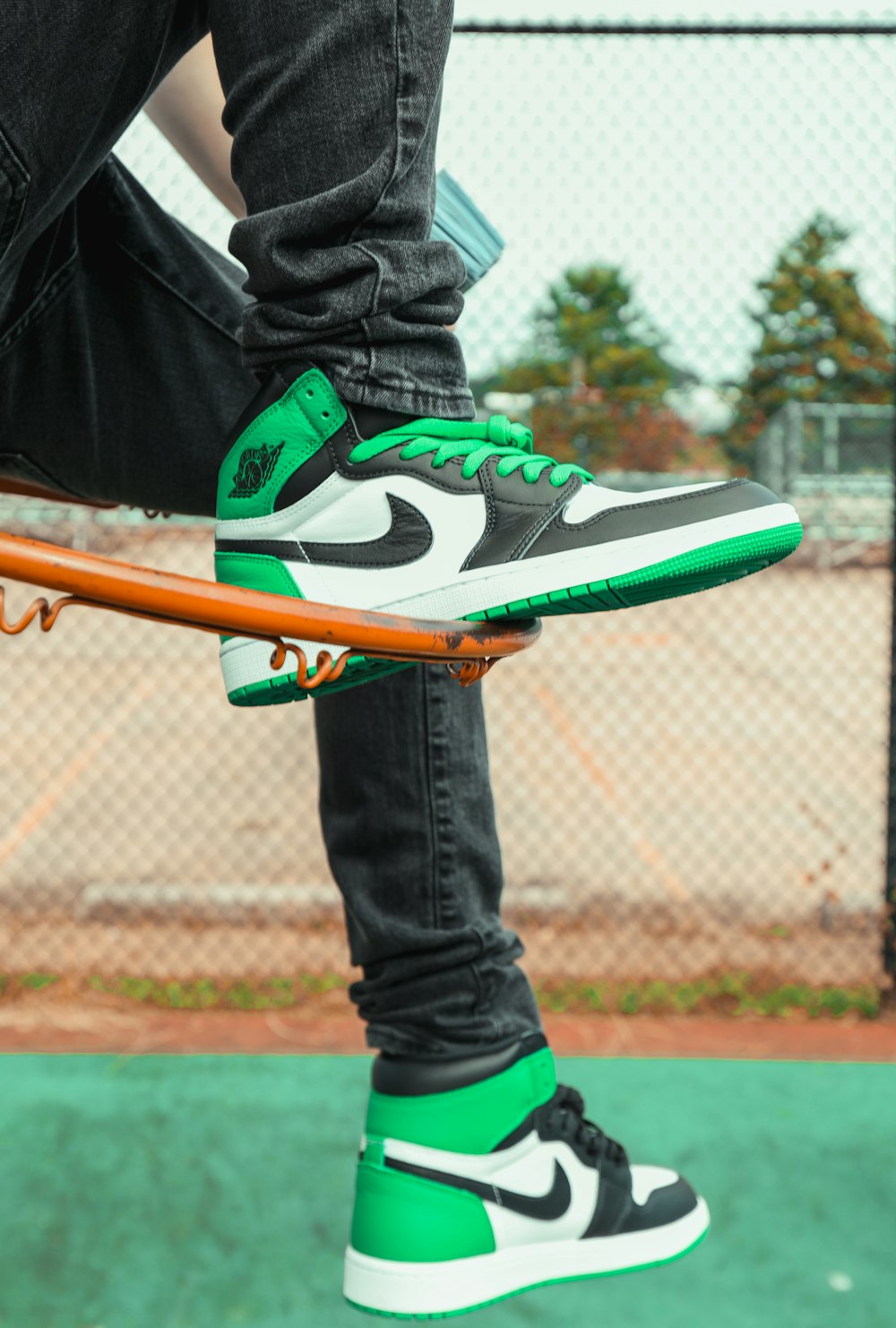 a person riding a skateboard on a green surface