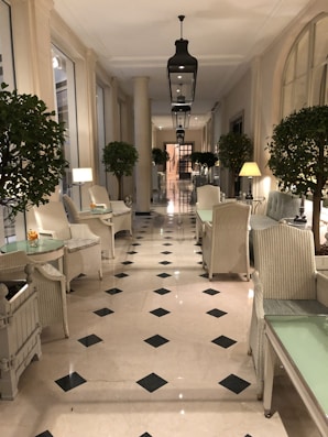 a long hallway with chairs, tables and lamps