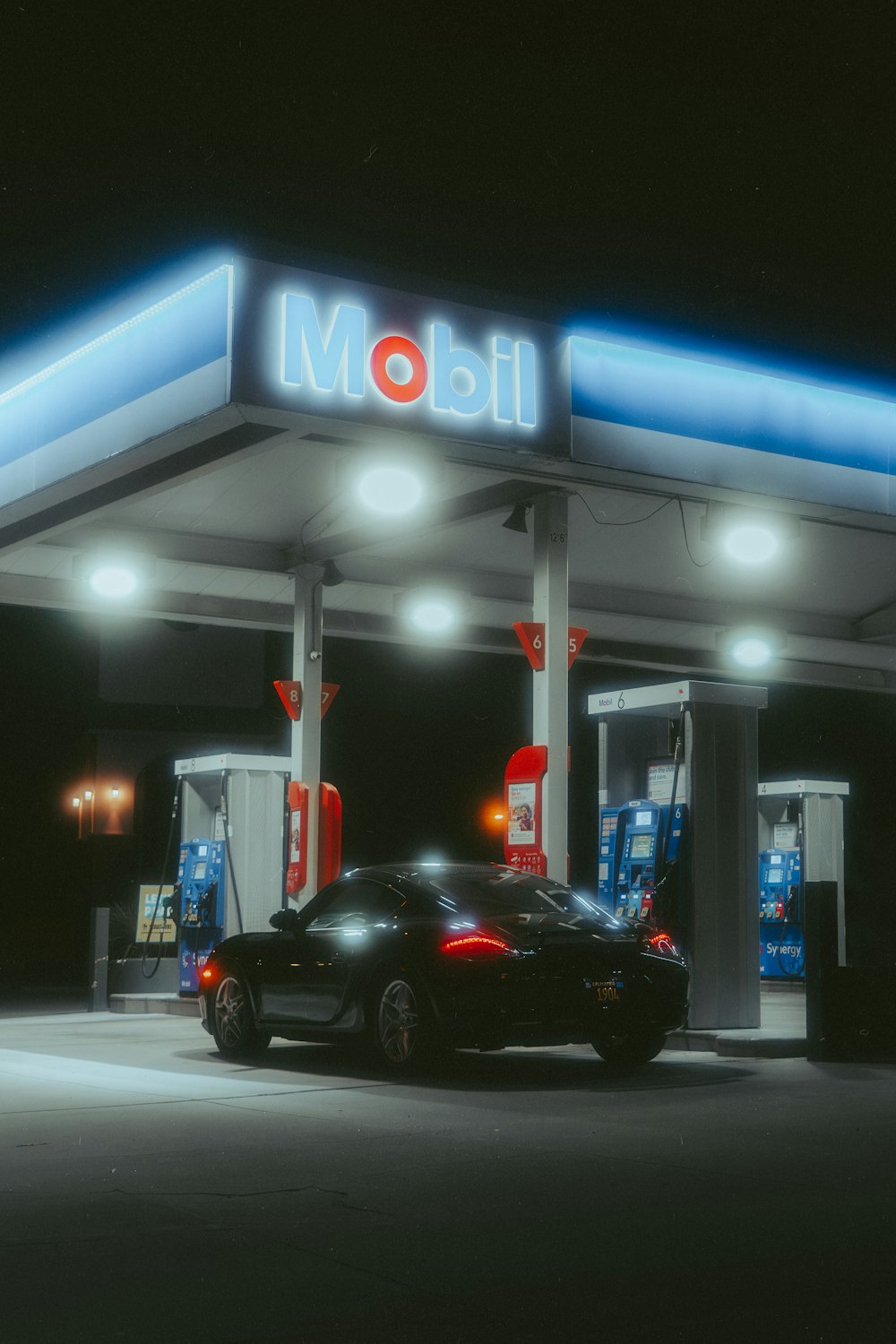 a car is parked in front of a gas station