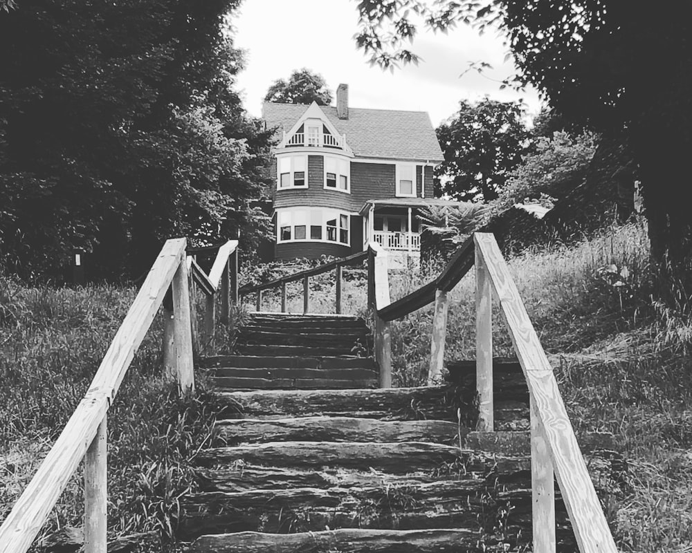 a black and white photo of a set of stairs leading to a house