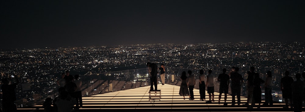 a group of people standing on top of a tall building