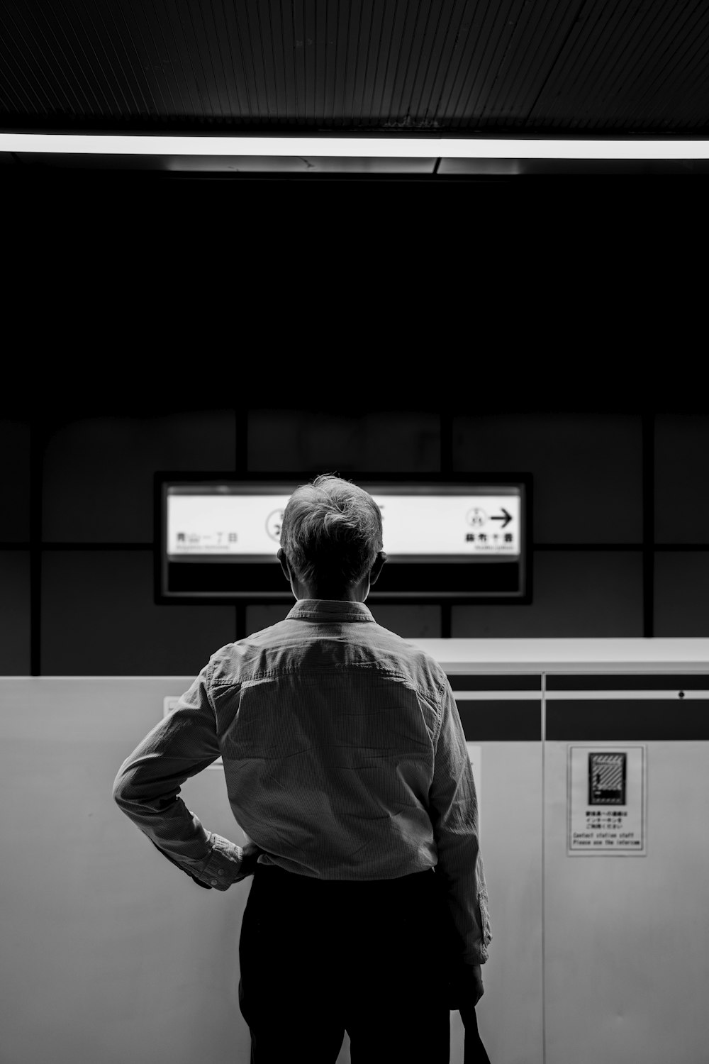 a man standing in a room with his hands on his hips