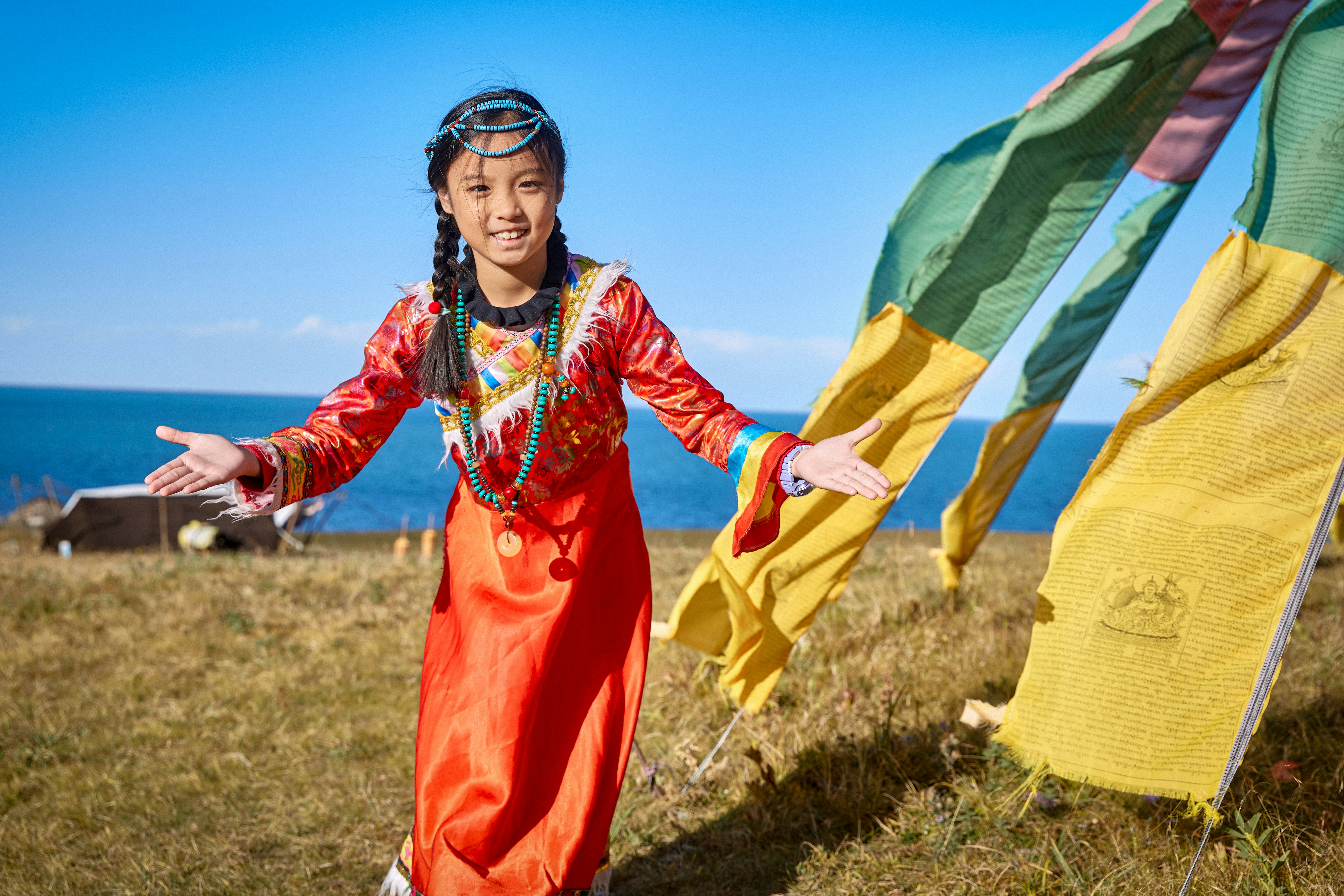 Young girl in traditional clothing by the sea