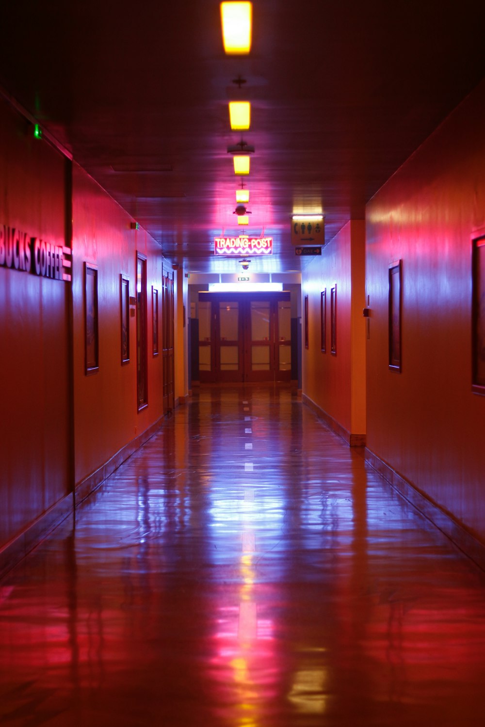 a long hallway with red and blue lights